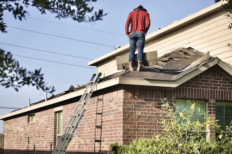 Professional roofer working on a residential roof in Arlington Hills